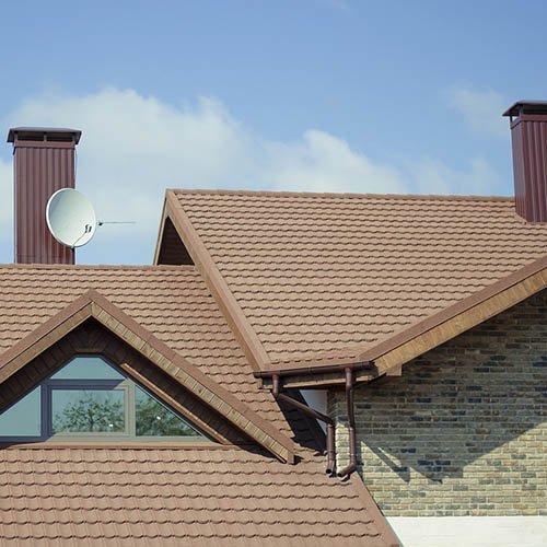 Modern home roof with brown shingles installed by a roofing contractor in Royal Palm Beach.